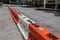City street divided by orange and white hard plastic traffic barriers, urban construction site