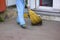 City street male or female sweeper cleaning pavement