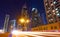 City street and modern skyscrapers at night