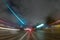 CITY STREET AT NIGHT WITH MOTION BLURRED LIGHTS OF FAST MOVING CARS, MODERN CITYSCAPE, RUSH ON THE STREET