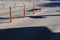 City street with road markings. Orange barrier posts on the road