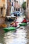 City tour by tourists with kayak, narrow channel, Venice, Italy