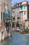 City tour by tourists with motorboat, side narrow channel , Venice, Italy