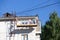 City Tula. Russia - July 07, 2021: A male house painter paints a residential building on a front lift