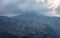 City urbanization view from hilltop with huge construction and dramatic sky