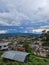 City urbanization view with mountain range at background at morning from flat angle