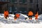 City utility workers in bright orange suits remove snow from city streets: Kaluzhskiy region, Russia - February 2021