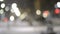 City view lights, falling snow, night street, bokeh spots of headlights of cars