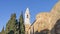 The city walls and the bell tower of the Duomo of Pienza illuminated by the morning sun, Siena, Tuscany, Italy