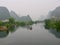 The city of Yangshuo, China with the town nestled in karst mountains in the mist and clouds.