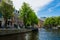 Cityscape of Amsterdam, Netherlands. Parking near the canal. Dutch urban architecture. Tourism in Europe