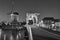 Cityscape, black-and-white - evening view of the city canal with drawbridge and windmill, the city of Leiden