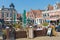 Cityscape centre square of Makkum with people sitting at terracce