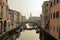Cityscape of Chioggia historic city center. Canal Vena with boats.