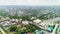 Cityscape with colorful buildings surrounded by trees