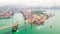 Cityscape drone aerial view of Hong Kong city, port industrial district, cargo container ship, cranes, car traffic on bridge