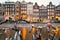 Cityscape - evening view from bicycles to houses with festive decorations and a city channel with boats, city of Amsterdam