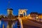 Cityscape - evening view of the city canal with drawbridge and windmill, the city of Leiden