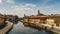 Cityscape of Gaggiano, just outside of Milan. Colourful houses reflected in the Naviglio Grande canal waterway and