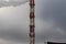 The cityscape, the high chimney boiler room against the sky.