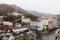 Cityscape, houses and carpark with trees and mountain with snow on it in the morning in Hokkaido, Japan