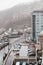 Cityscape, houses and carpark with trees and mountain with snow on it in the morning in Hokkaido, Japan