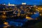 Cityscape of illuminated Toledo in evening with view of Tagus River