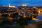 Cityscape of illuminated Toledo in evening with view of Tagus River