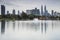 Cityscape of Kuala Lumpur at noon with Petronas Towers reflected on the Titiwangsa Lake