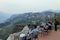 Cityscape on the mountain with fog and trees with tourists relax and sitting for take a view in summer in the dusk in Sa Pa.