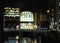 a cityscape night view of leeds showing the river aire running under the dark arches and the southern entrance to the station