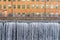 Cityscape of old industrial buildings with waterfall and water reservoir in the city of Norrkoping Sweden.