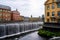 Cityscape of old industrial buildings with waterfall and water reservoir in the city of Norrkoping Sweden.