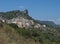 Cityscape of old pictoresque village Ulassai with limestone climbing rock and green vegetation and mountains at