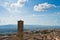 Cityscape over the roofs and surrounding landscape with bell tower of Volterra duomo in front, Tuscany