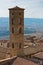 Cityscape over the roofs and surrounding landscape with bell tower of Volterra duomo in front, Tuscany