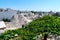 Cityscape over the traditional rock roofs of the traditional Trulli houses in the streets of Alberobello city, Italy, Apulia