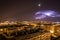 Cityscape of Pamplona surrounded by buildings and lights during the night in Spain