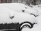 Cityscape - parked cars covered with snow