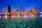 Cityscape in reflection of Ho Chi Minh city at beautiful twilight, viewed over Saigon river.