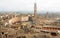 Cityscape of Siena, Tuscany. Tile roofs and 14th century tower Torre del Mangia, Italy. UNESCO Heritage Site