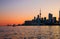 Cityscape - silhouettes of skyscrapers, calm lake old sail ship and yacht.