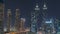 Cityscape with skyscrapers of Dubai Business Bay and water canal aerial night timelapse.