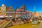 Cityscape of a small, beautiful German town with the traditional half-timbered architecture and canal with an old wooden sailboat