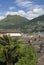 Cityscape on a sunny day in the city of Lugano, Switzerland. Roofs of houses, mountains in the background.