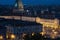 Cityscape of Torino Turin, Italy at night with details of large square, streets and city lights. The Mole Antonelliana in the ba