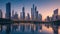 A cityscape at twilight, with skyscrapers aglow and reflections in a calm river.