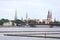 Cityscape view of Old Riga house and church towers in background and yach pier in foreground