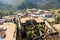 Cityscape view of Rooftops of houses covered in green unroasted coffee beans drying in the sun