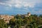 Cityscape of Volterra over the roofs with surrounding landscape, Medici fortress in background, Tuscany